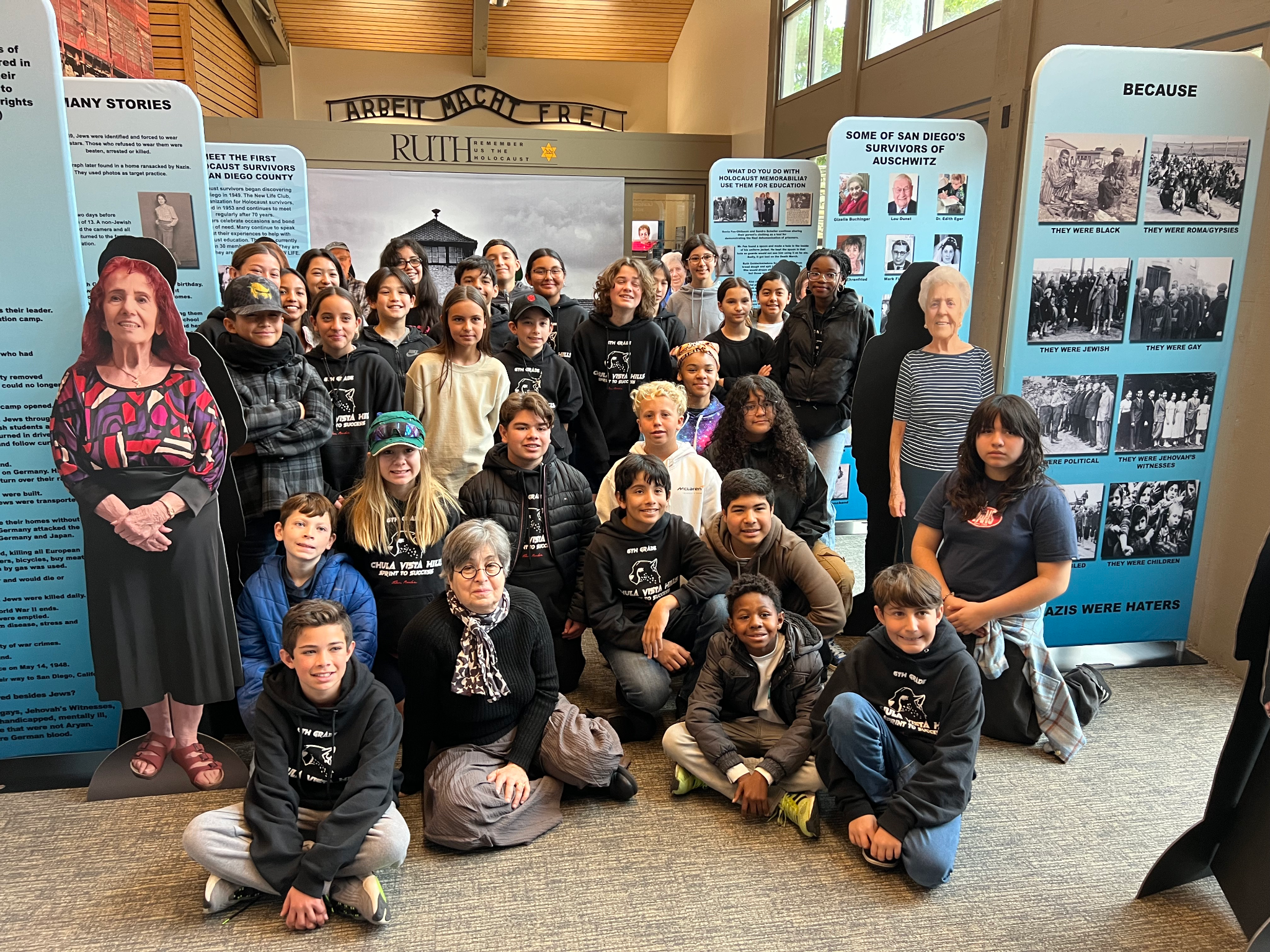 Students visiting a RUTH Holocaust education exhibition with survivor displays and historical panels